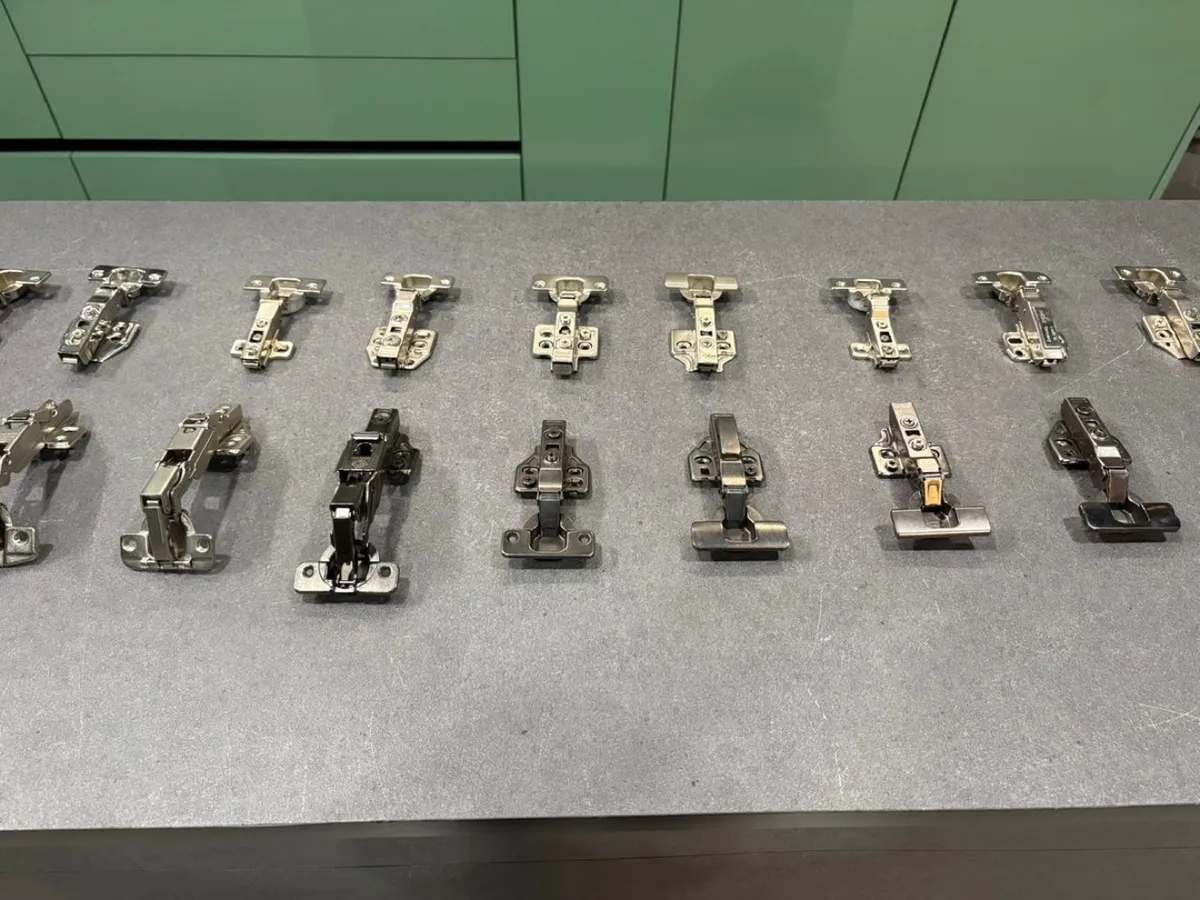 Row of concealed soft-close cabinet hinges