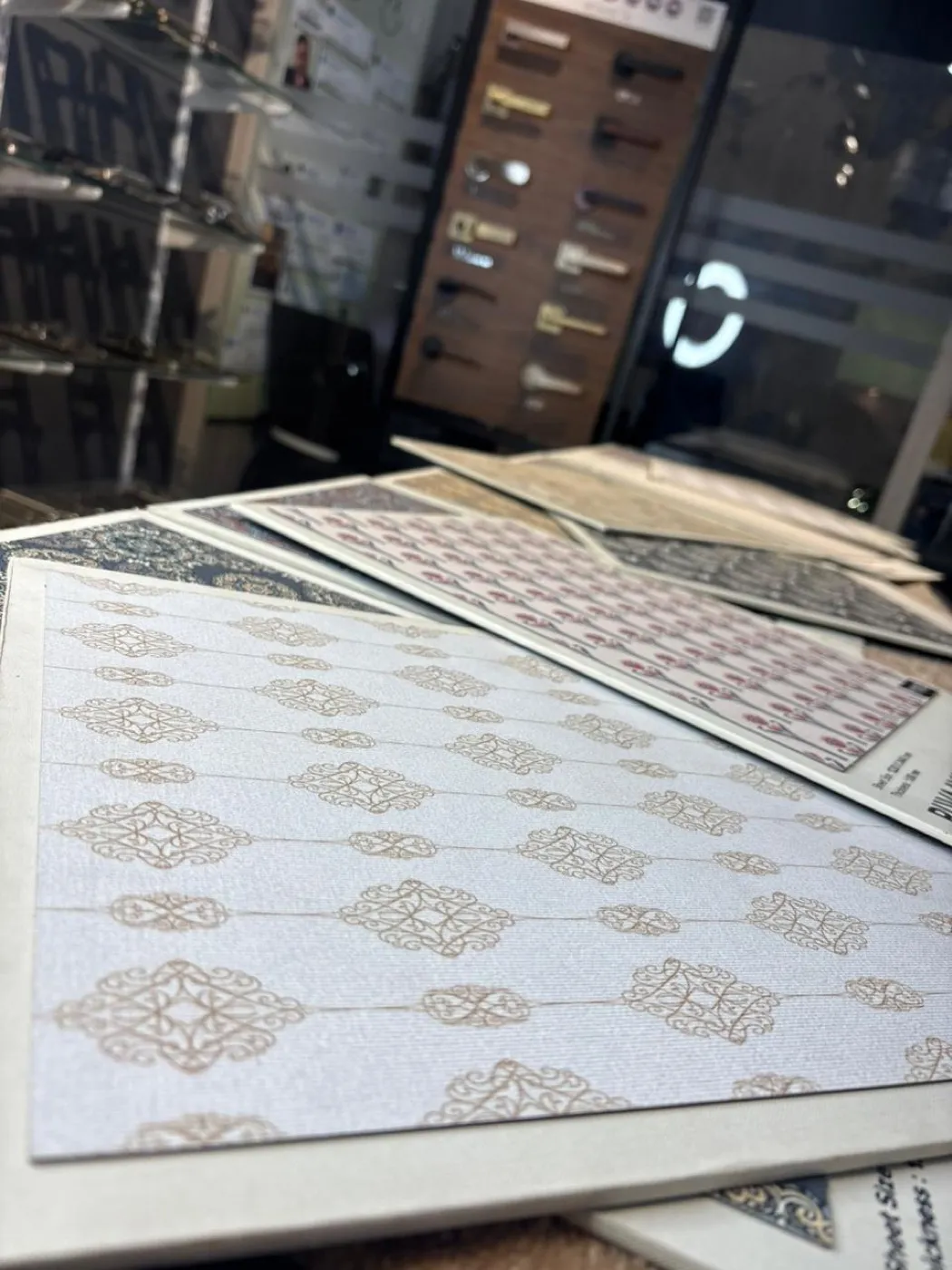 Patterned decorative laminate sheets fanned out on a showroom counter