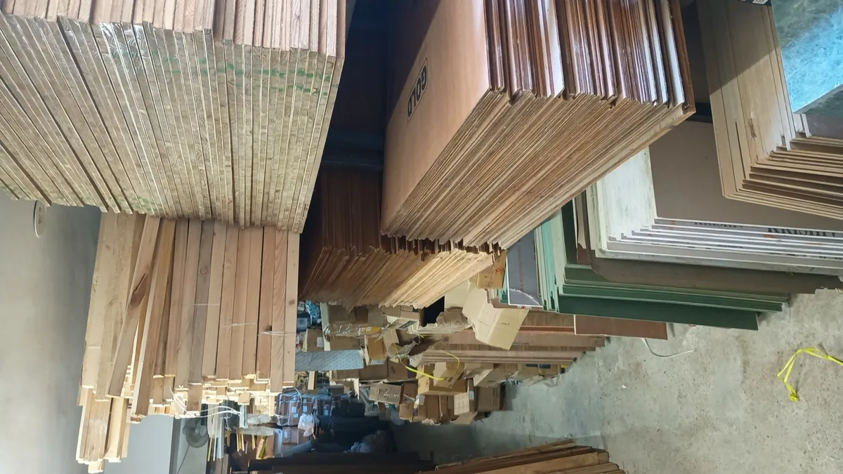 Edges of stacked plywood and boards showing the internal layers