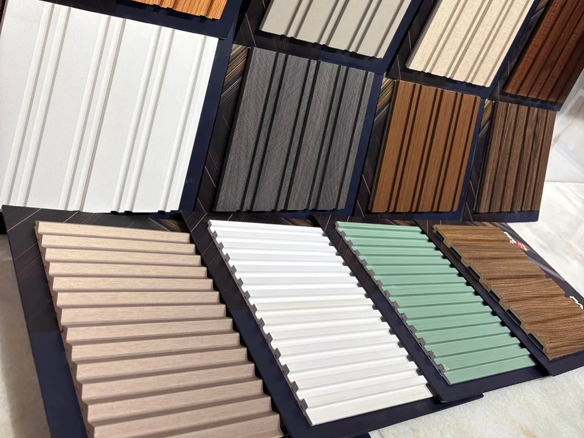 A display of fluted wall louver panels in wood, white, grey and pastel tones