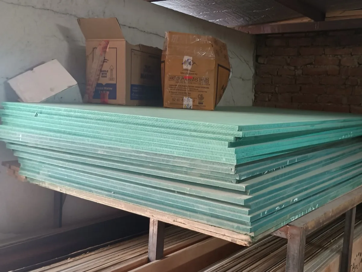 Stack of green-faced HDHMR boards in a warehouse