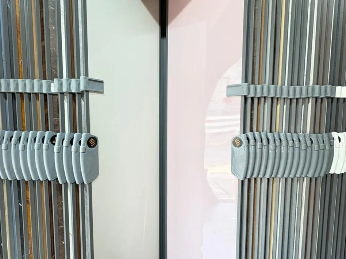 Showroom rack of laminate and panel sheets in whites, greys and wood tones