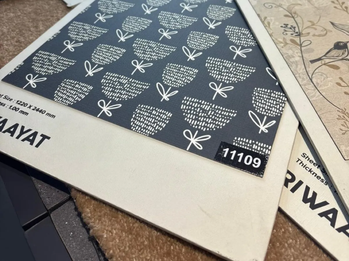 Patterned decorative laminate sheets fanned out on a counter