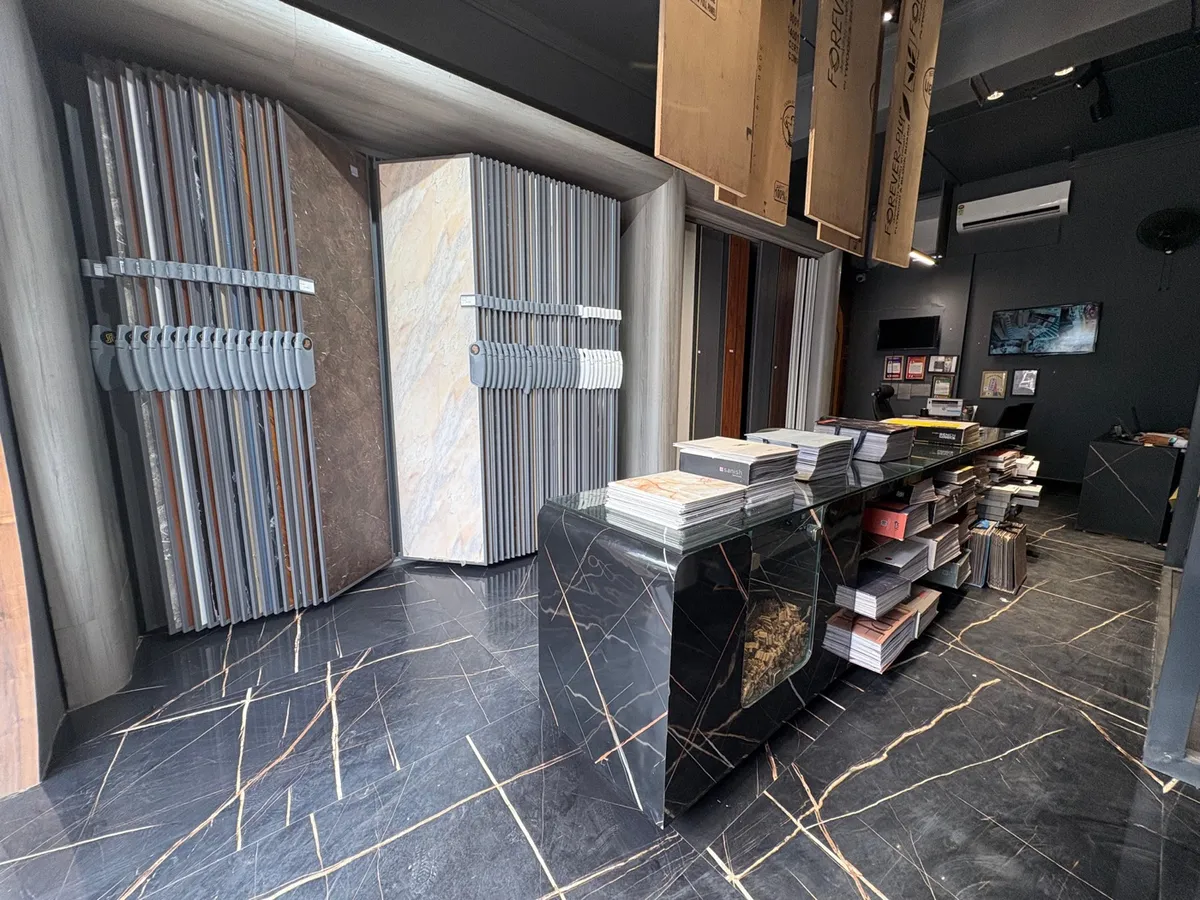 Sri Sri Plywoods showroom interior with sheet racks and a marble-finish display counter